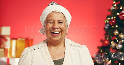 Buy stock photo Smile, christmas and portrait of senior woman in studio with decorations for festive tradition. Happy, santa hat and elderly female person from Mexico with pride for xmas holiday by red background.