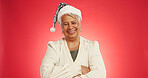 Christmas, happy and portrait of mature woman in studio for holiday, vacation and festive season. Mockup space, hat and person for tradition, xmas celebration and December event on red background