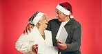 Gift box, christmas and senior couple in studio with festive, holiday or marriage tradition. Excited, happy and elderly man with woman for opening present in xmas season together by red background.