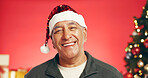 Happy, christmas and portrait of senior man in studio with decorations for festive tradition. Smile, santa hat and elderly male person from Mexico with pride for xmas holiday by red background.