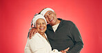 Christmas, hug and senior couple in studio with smile, bonding and relationship in retirement. Love, happy man and woman together with marriage, portrait and festive holiday on red background space