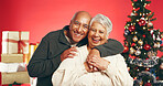 Happy, christmas and portrait of senior couple in studio with love, festive and marriage tradition. Hug, retirement and elderly man embracing woman by xmas tree for celebration by red background.