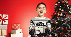 Happy, christmas and portrait of child in studio with mockup space for tradition, festive or holiday. Smile, crossed arms and boy kid from Portugal with confidence for xmas season by red background.