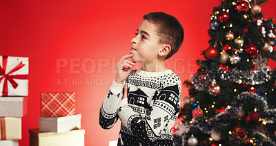 Buy stock photo Thinking, child and boy with presents, Christmas or celebration for festive event or red background. Studio, reflection and ideas for December holiday, gifts and decorations for Xmas and season