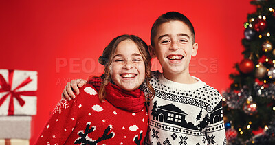 Buy stock photo Christmas, portrait and children hug with siblings for love and holiday celebration. Girl, happy kids and embrace boy on xmas with brother, sister and family with laugh on red studio background