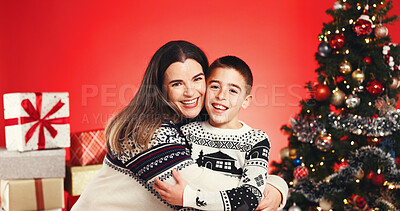 Buy stock photo Christmas, portrait and people hug with child for love and holiday celebration. Happy woman, son and embrace for xmas event with smile, festive season and family with support on red studio background