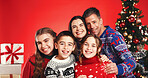 Happy, christmas and portrait of family in studio with tradition, festive or holiday celebration. Smile, bonding and children with parents for xmas season together with decorations by red background.