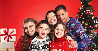 Buy stock photo Happy, Christmas and portrait of family in studio with tradition, festive or holiday celebration. Smile, bonding and children with parents for xmas season together with decorations by red background.