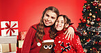 Christmas, portrait and girls hug with siblings for love, holiday celebration and festive season. Smile, children and embrace on xmas with sisters, family and vacation on red studio background