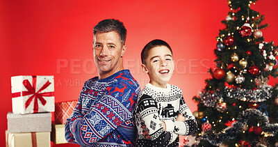 Buy stock photo Arms crossed, Christmas and portrait of father with son in studio for celebration or tradition. Family, presents or tree with boy child and man parent isolated on red background for holiday season