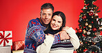 Christmas, hug and portrait with couple in studio together for bonding and gift or present. Smile, celebration and love with man and woman embracing on red background for festive tradition or holiday