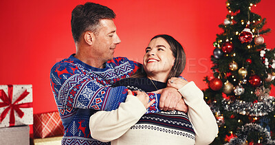 Buy stock photo Christmas, hug and smile with couple in studio together for bonding and gift or present. Happy, celebration and love with mature man and woman on red background for festive tradition or holiday