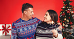 Christmas, hug and sparkler with couple in studio together for bonding and gift or present. Firework, celebration and love with mature man and woman on red background for festive tradition or holiday