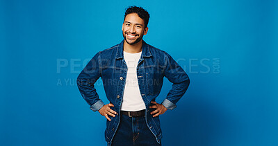 Buy stock photo Happy, fashion and portrait of man on blue background for trendy style, casual clothes and confidence. Mockup space, studio and person with positive attitude, smile and pride in denim for aesthetic