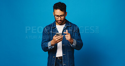 Buy stock photo Phone, confused and typing with man in studio for phishing, fake profile and social media scam. Clickbait link, password check and mockup space with person on blue background for security update