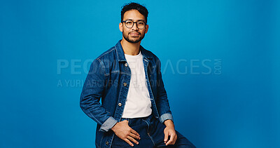 Buy stock photo Optometry, blue background and portrait of man with glasses for prescription lens, vision and spectacles. Studio, mockup space and person with confidence for fashion frames, trendy eyewear and sight
