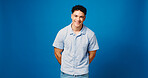 Portrait, smile and man in studio, fashion and confident personality on blue background. Mockup space, pride and person with happiness, gen z and friendly with stylish clothes, calm and streetwear