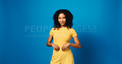 Buy stock photo Smile, portrait and woman in studio for fashion, confidence and happiness on mockup space. Aesthetic, style and female model with trendy clothes, jumpsuit and outfit on blue background in Brazil