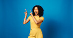 Portrait, pointing up and woman in studio with promotion, announcement and offer on blue background. Model, space and happy person with hand gesture, smile and opportunity with decision or choice