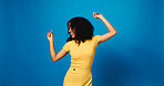 Happy, African woman and dancing in studio for good news, lottery winner and giveaway reward. Smile, person and energy with moving rhythm for announcement, promotion and celebrate on blue background