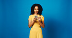 Browsing, online and woman with smartphone, studio and communication with contact and mock up space. Blue background, happy and person with mobile, texting or message on social media and digital chat