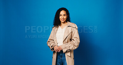 Buy stock photo Happy, portrait and woman in studio for fashion, confidence and smile on mockup space. Casual, style and female model with trendy clothes, jacket and outfit for aesthetic on blue background in Brazil