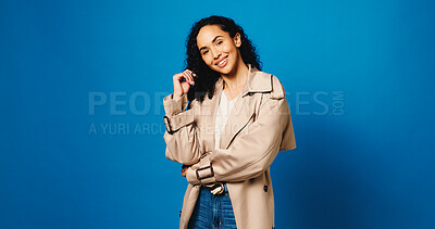 Buy stock photo Clothes, portrait and smile of woman fashion designer in studio to model trendy outfit on space. Aesthetic, mockup and small business with happy design employee isolated on blue background for style