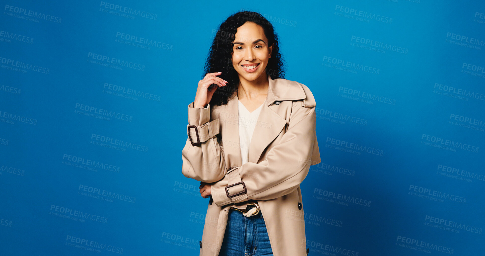 Buy stock photo Fashion, happy and portrait of woman in studio with trendy, trench coat or cool outfit with confidence. Smile, mockup space and female person from Brazil with stylish clothes by blue background.