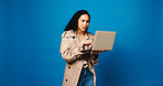 Laptop, reading and woman fashion designer in studio for market research of trendy style on space. Clothes, computer and small business with design employee isolated on blue background mockup