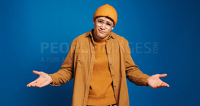 Buy stock photo Man, portrait and student with shrug in studio, question or dont know for academic future or choice by space. Doubt, confused or person with uncertainty for university decision on blue background
