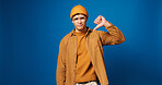 Portrait, mockup and man in studio with thumbs down, choice and decision for university rating. Disagree, fail and college student with vote, dislike hand sign and opinion on blue background space.