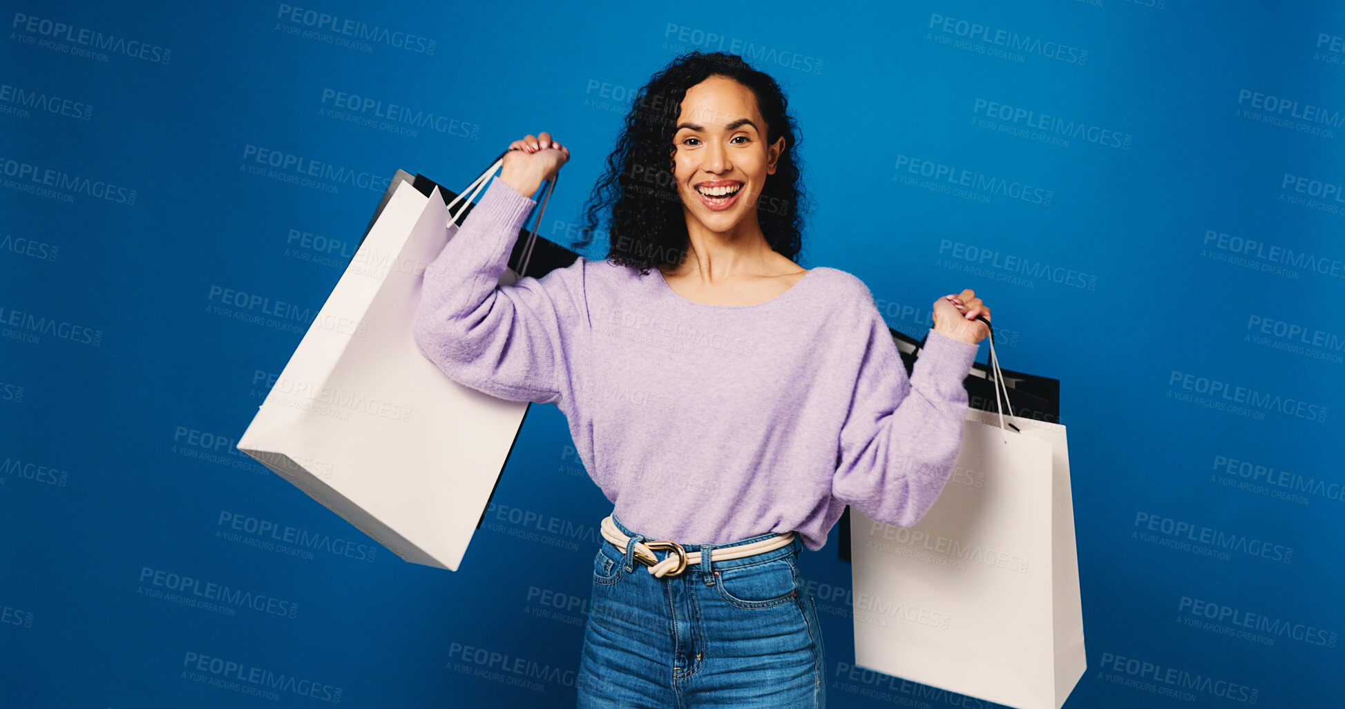Buy stock photo Happy woman, portrait and fashion with shopping bag in studio for discount on a blue background. Female person, shopper or model with smile or gifts for purchase spree, deal  or choice on space