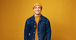 Man, fashion and happy in studio portrait with beanie, streetwear and trendy style on background. Person, smile and pride with confidence, edgy clothes and hat with mock up space in Costa Rica