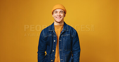 Buy stock photo Man, fashion and happy in studio portrait with beanie, streetwear and trendy style on yellow background. Person, smile and pride with confidence, edgy clothes and hat with mock up space in Costa Rica