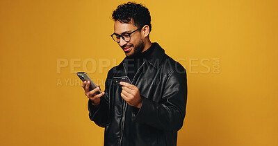 Buy stock photo Phone, credit card and smile with man in studio for online shopping, fintech and savings account. Digital payment, banking app and mockup space with person on yellow background for ecommerce purchase