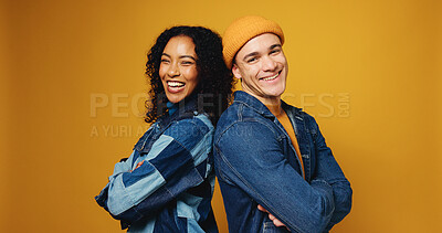 Buy stock photo Portrait, arms crossed and happy couple in studio for fashion, love and support on yellow background. Man, woman and stylish clothes with confidence, laugh and care for interracial relationship