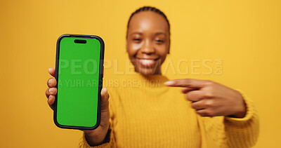Buy stock photo Happy, black woman or portrait with phone or green screen for advertising on a studio background. Female person, user or pointing with smile on mobile smartphone display for marketing on mockup space