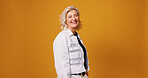 Laugh, startup and portrait of mature woman in studio for fashion designer, entrepreneur or pride. Stylist, about us and joke with person on orange background for creative business on mockup space