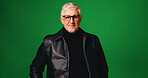 Studio, portrait and mature man with glasses, detective or ambitious for career growth or promotion. Green background, private investigator and person with eyewear, space and pride for justice in USA