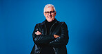 Portrait, fashion designer and man in studio, arms crossed and happy tailor on blue background. Mature person, space and small business owner with career ambition, entrepreneurship or stylish clothes