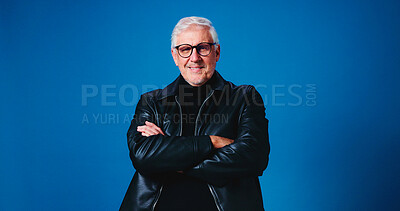 Buy stock photo Portrait, fashion designer and man in studio, arms crossed and happy tailor on blue background. Mature person, space and small business owner with career ambition, entrepreneurship or stylish clothes