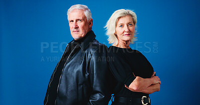 Buy stock photo Fashion, studio and portrait of senior couple for trendy outfit, cool clothes and style together. Marriage, space and mature man and woman with attitude, confidence and pride on blue background