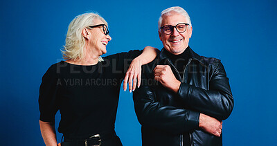 Buy stock photo Senior couple, fashion and smile in studio for love, laugh support on blue background. Man, woman and stylish clothes in retirement with confidence, funny and cool glasses with portrait together