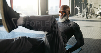 Buy stock photo Legs, exercise and mature black man in gym for core strength, workout and training on floor. Sports center, serious and person on fitness mat for wellness, health and stretching muscles for mobility