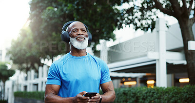 Buy stock photo Athlete, black man and listening to headphones, outdoor and streaming music with smartphone and app. Happy, mature person and mobile for playlist on website, fitness and smile for album or song