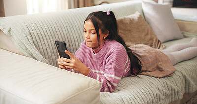 Buy stock photo Girl, child and typing with phone on sofa for social media update, online gaming and web addiction. Kid, smartphone and texting in home with streaming subscription, internet dependence and mobile app