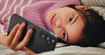 Girl, child and connection with phone on bed for social media browsing, texting or web addiction. Kid, relax and smartphone in home with streaming subscription, internet dependence and reading post