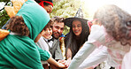 Halloween, hands together and happy with family outdoor for costume, celebration and trick or treat. Huddle, support and spooky tradition with group of kids and parents in backyard for holiday