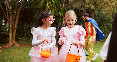 Buy stock photo Bucket, halloween and walking with girls outdoor together for celebration, fantasy or holiday. Bonding, candy and conversation with children friends in neighborhood for trick or treat tradition