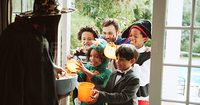 Buy stock photo Children, happy and candy at door on halloween for tradition, costume and trick or treat. Holiday, neighborhood kids and excited with bucket at house for sweets collection, dress up and celebration